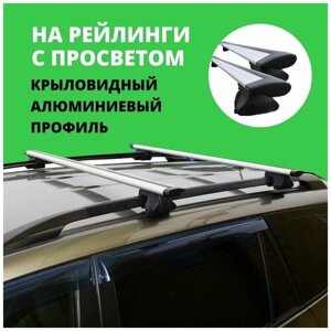 Багажник на крышу для Kia Sedona I (минивэн) 1998-2006 на рейлинги. Крыловидные дуги. Комплект из 2-х поперечин и 4-х опор багажника